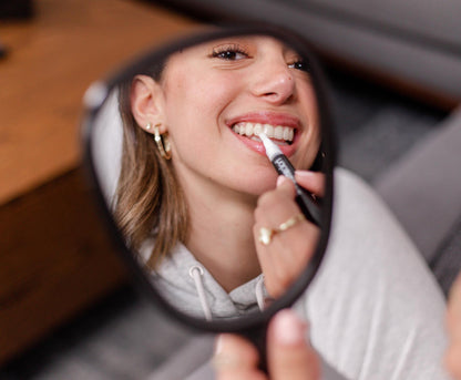 image of girl applying quick touch ups with her teeth whitening pen